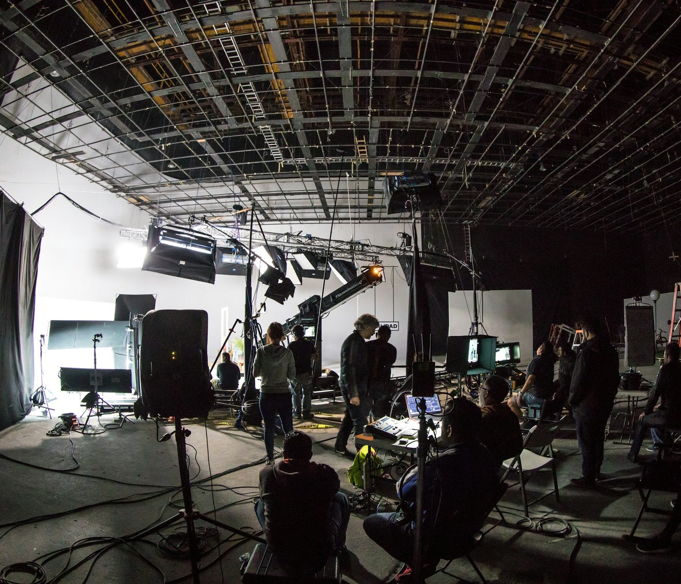 A commercial shoot in progress on a lit soundstage